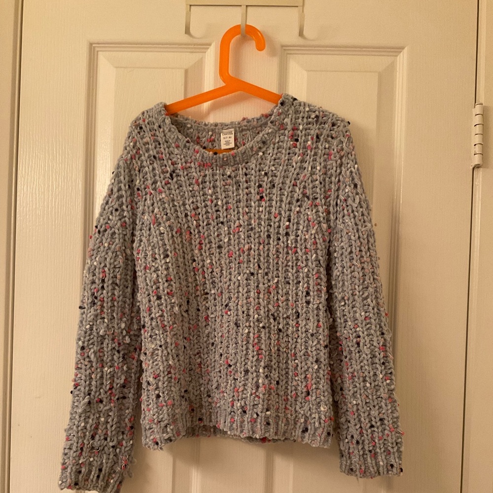 This is a light blue kids sweater it has rainbow poke a dots super soft!